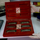 A member of the federal police shows a box with swastikas containing harmonicas for children at the Interpol headquarters in Buenos Aires, Argentina (AP Photo/Natacha Pisarenko)